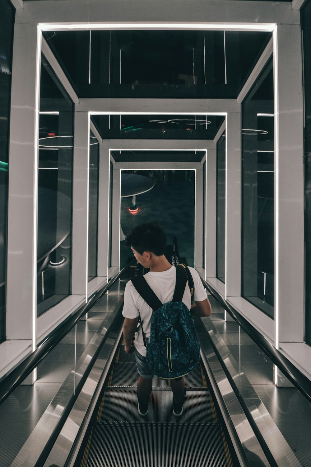 man riding escalator