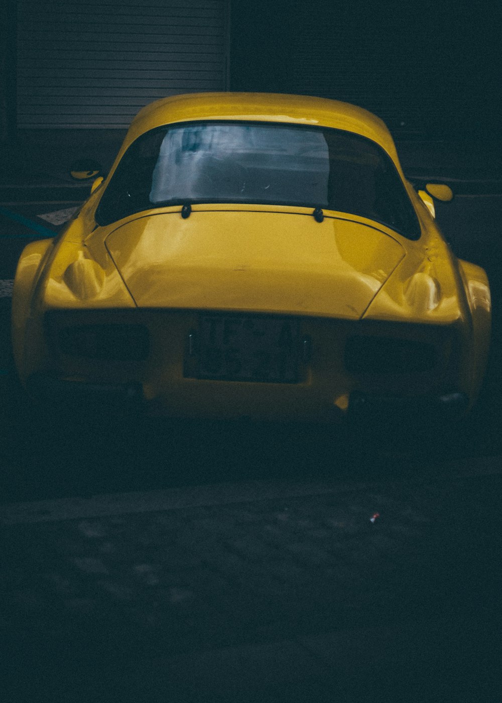 yellow car parked at sidewalk