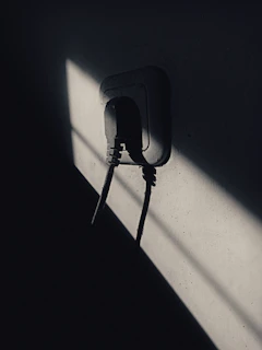 Close-up of hands holding a sleek electrical socket purchased from İşıqnəbzi.