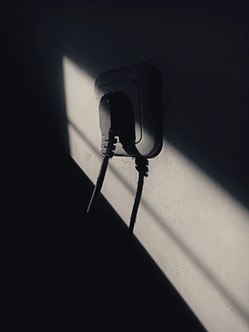 An electrician from Surgesparks carefully installing a new socket outlet in a cozy local shop.