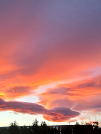 A vibrant sunset background with a quote about creativity and daily inspiration.