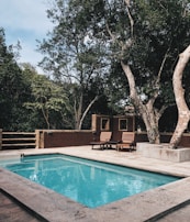 two lounge chairs near swimming pool
