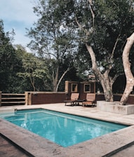 two lounge chairs near swimming pool