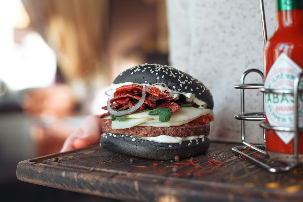 black burger with cheese selective focus photography