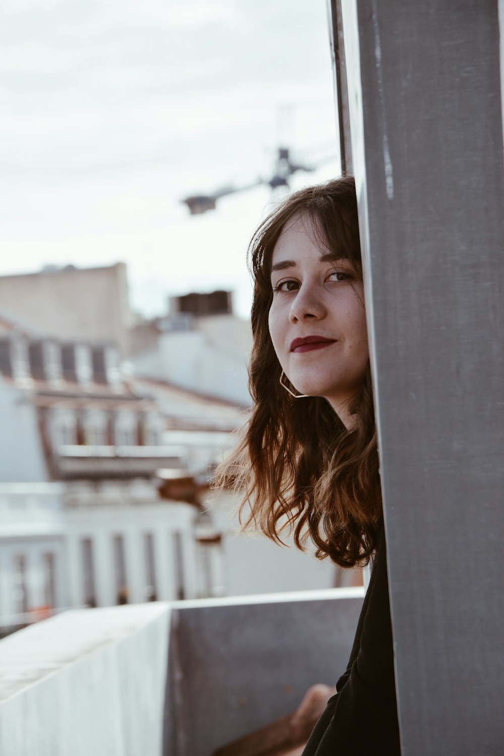 woman standing beside gray concrete wall during daytime