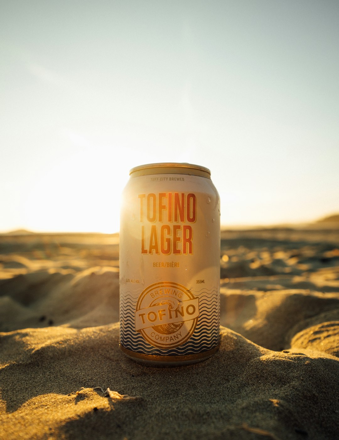 Tofino Lager beer can on sand