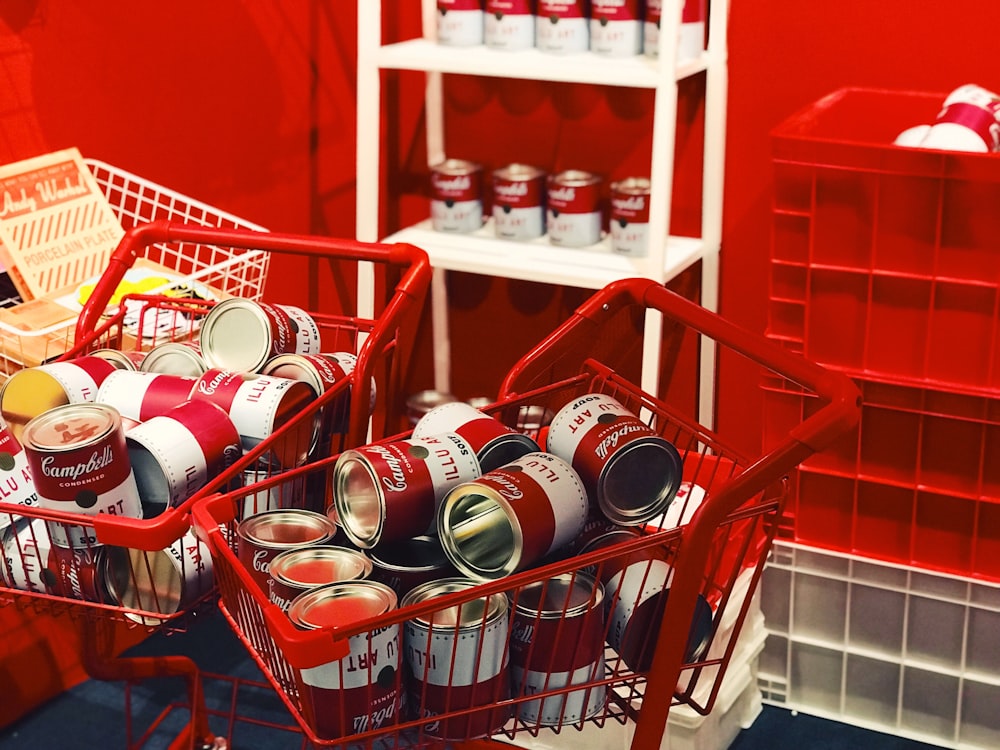 red labeled can lot on shopping cart