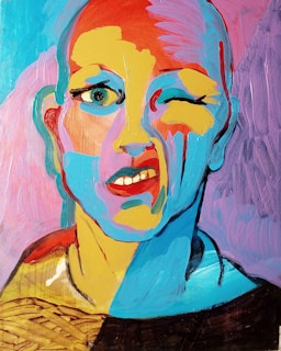 A colorful abstract portrait features a face with exaggerated expressions. The style uses a combination of bold primary and pastel colors, creating a vibrant and playful appearance. The facial features are depicted with thick brushstrokes, giving it a textured look. The figure's one eye is open while the other is winking, accompanied by a playful smirk.