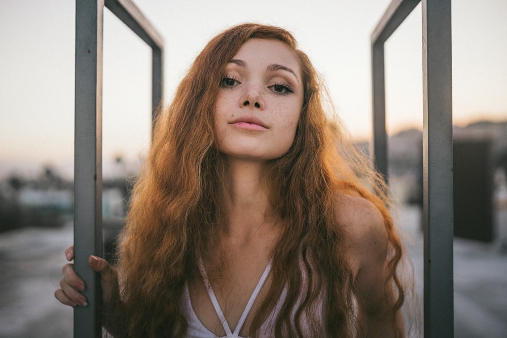 woman wearing white top taking selfie