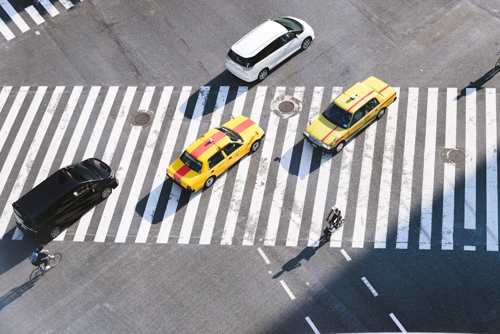 aerial photo of four vehicles on road at daytime