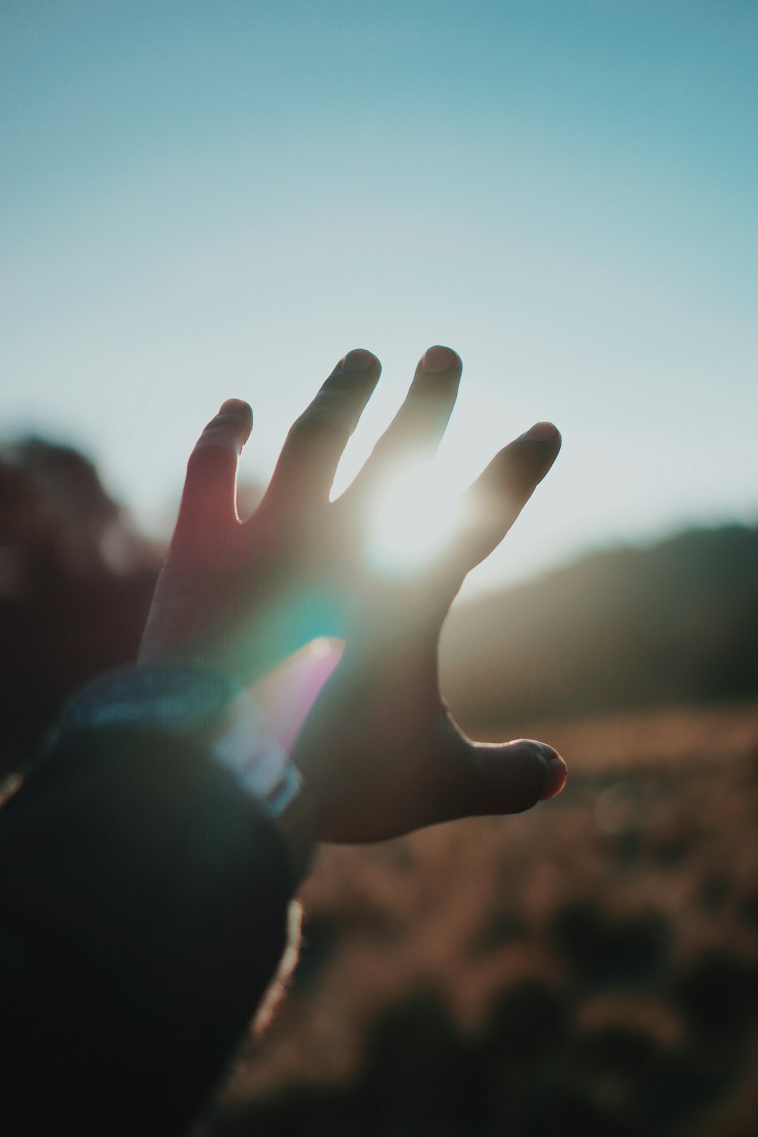 left person hand and bright light