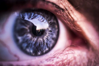 A close-up of a human eye reflecting a cosmic starry sky, symbolizing universal connection.