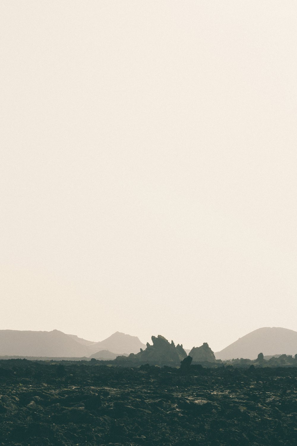 landscape photography of mountain under foggy sky