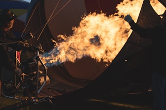 a man standing next to a hot air balloon