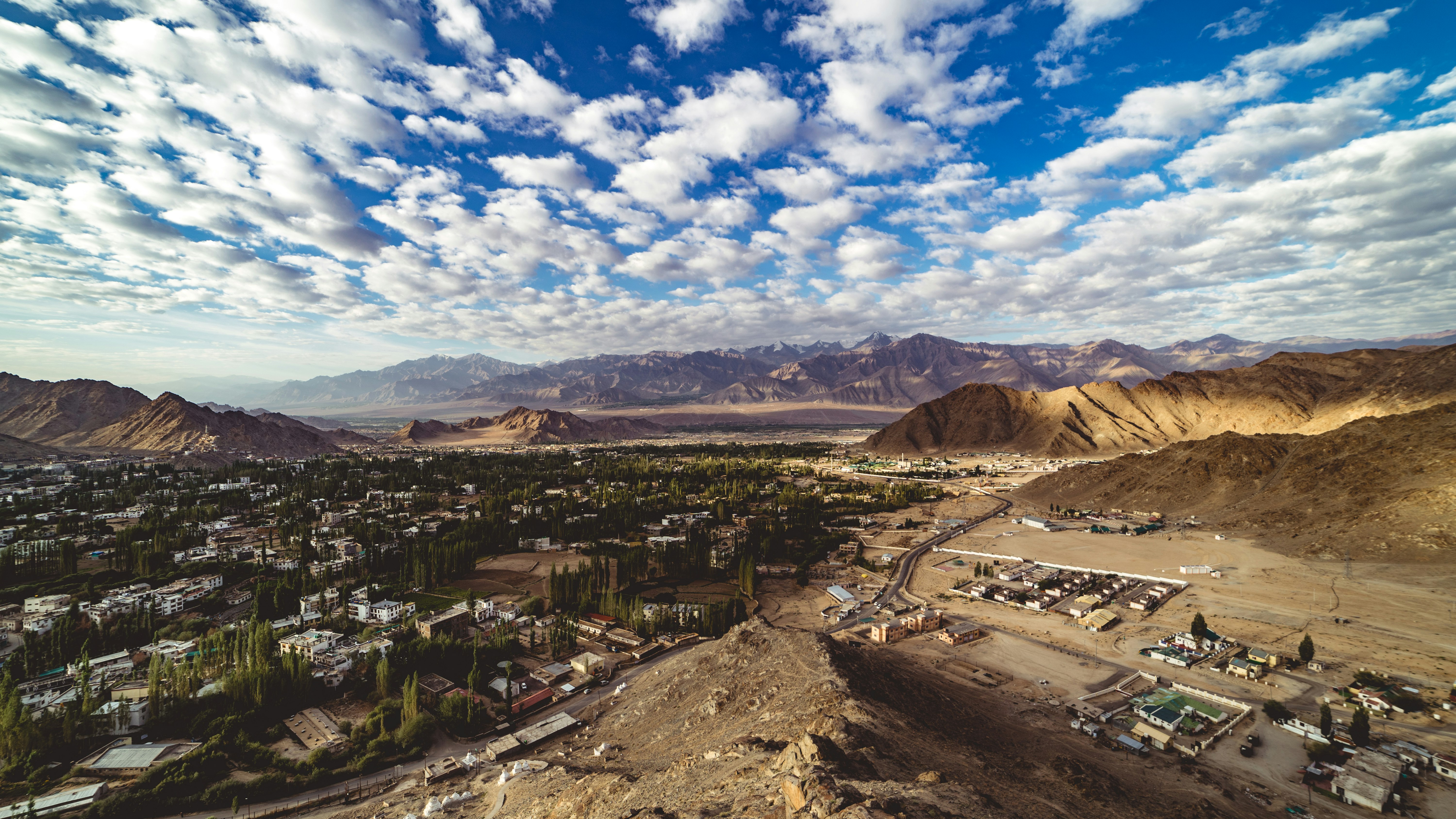 aerial photo of city in the middle of desert during day