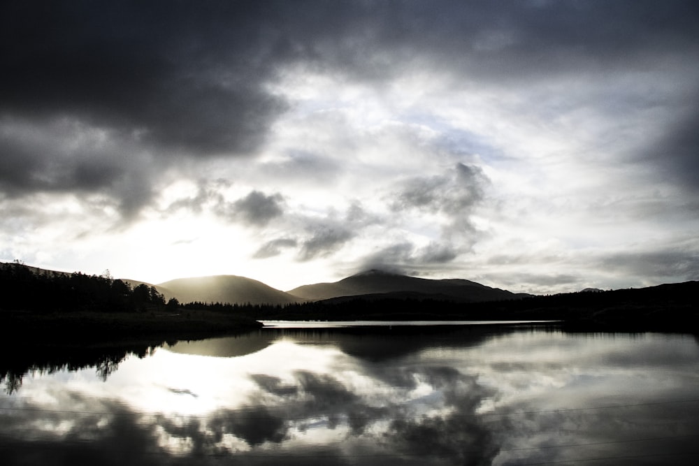 a large body of water under a cloudy sky