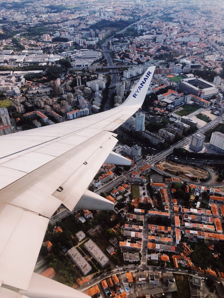 ryanair plane wing over european city