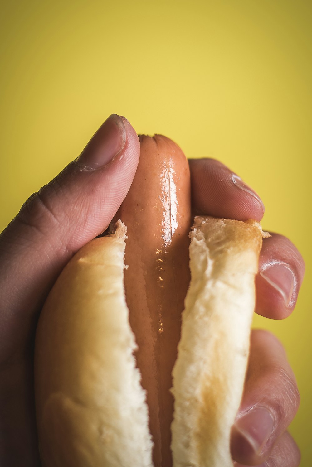 person holding sausage