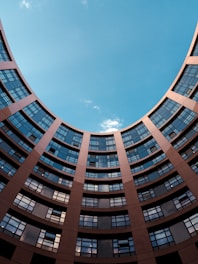 low-angle photography of gray building under blue sky at daytime
