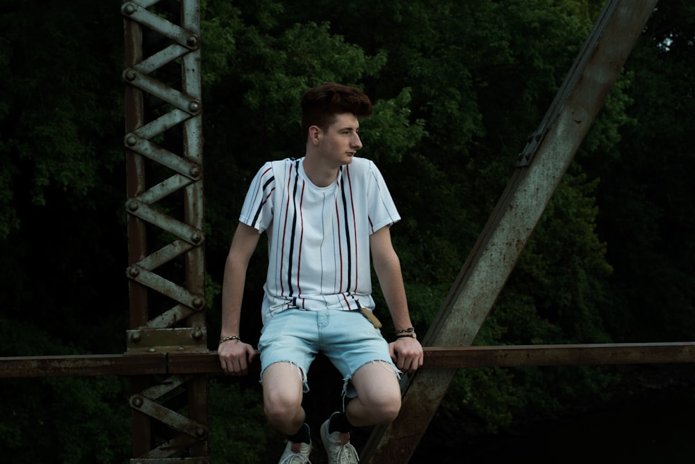 man sitting on bridge