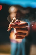 person holding lighted joint