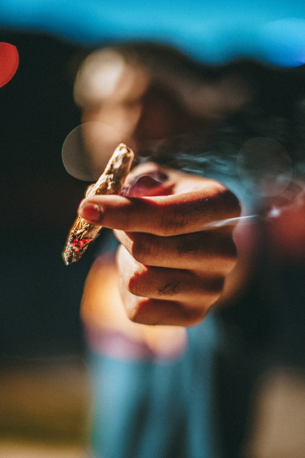 person holding lighted joint