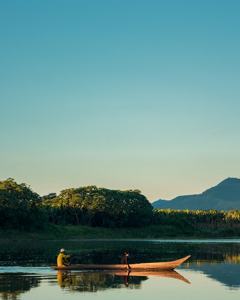 man riding brown wooden boat