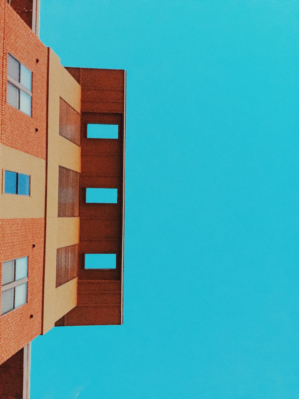 low-angle photo of brown concrete building