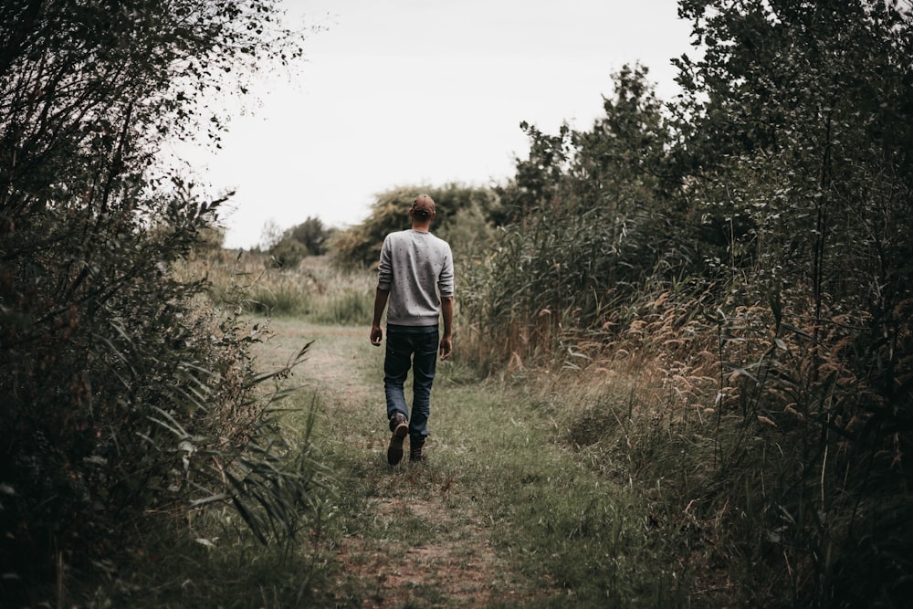 man walking on green grass