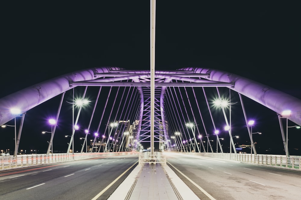 concrete bridge with lights during night