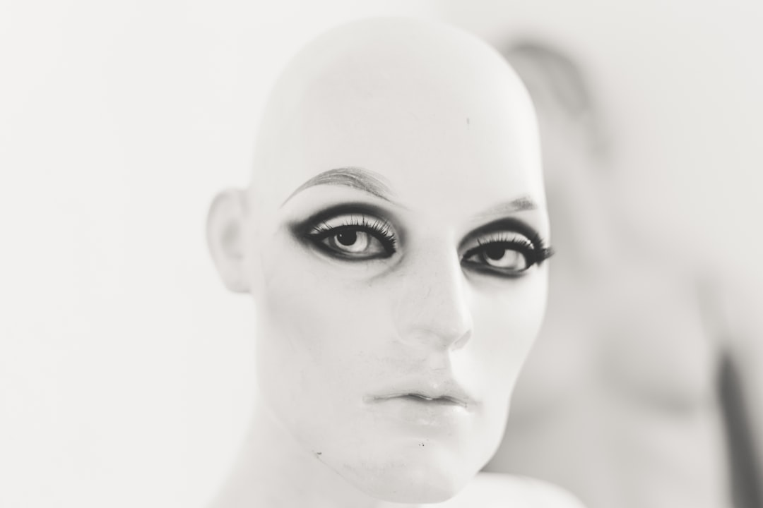 human face with black eyeshadow and mascara,