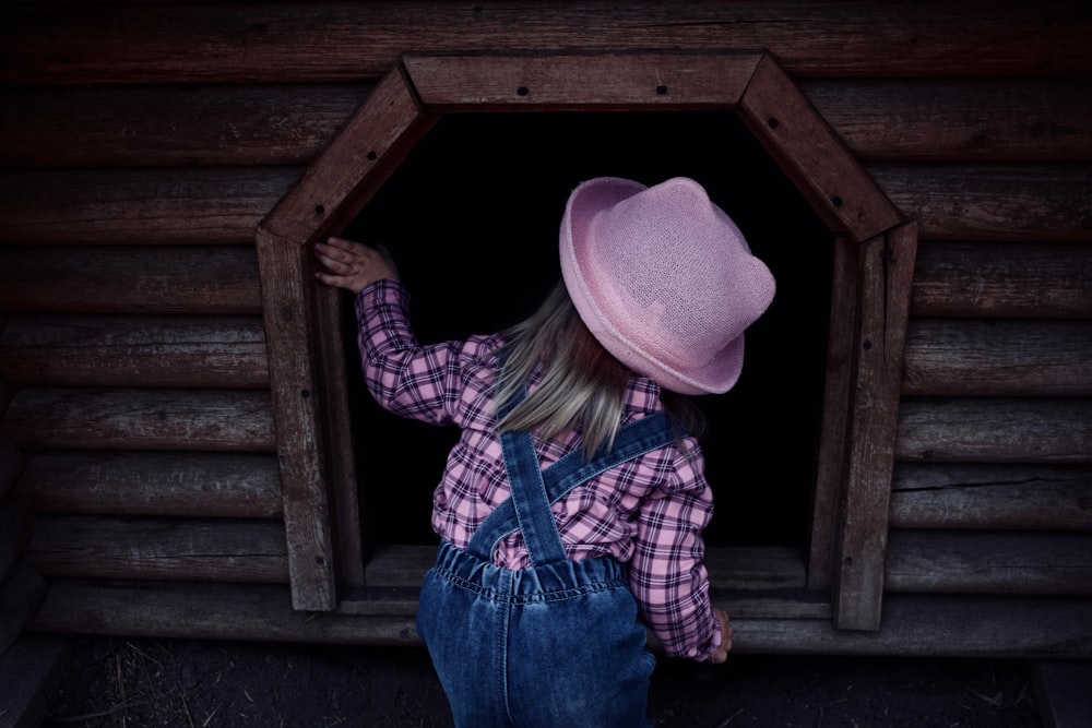 girl peeking on shed