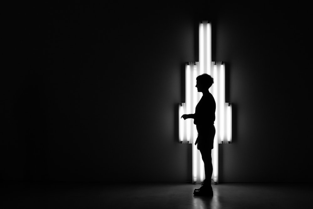 boy standing in front of lamp