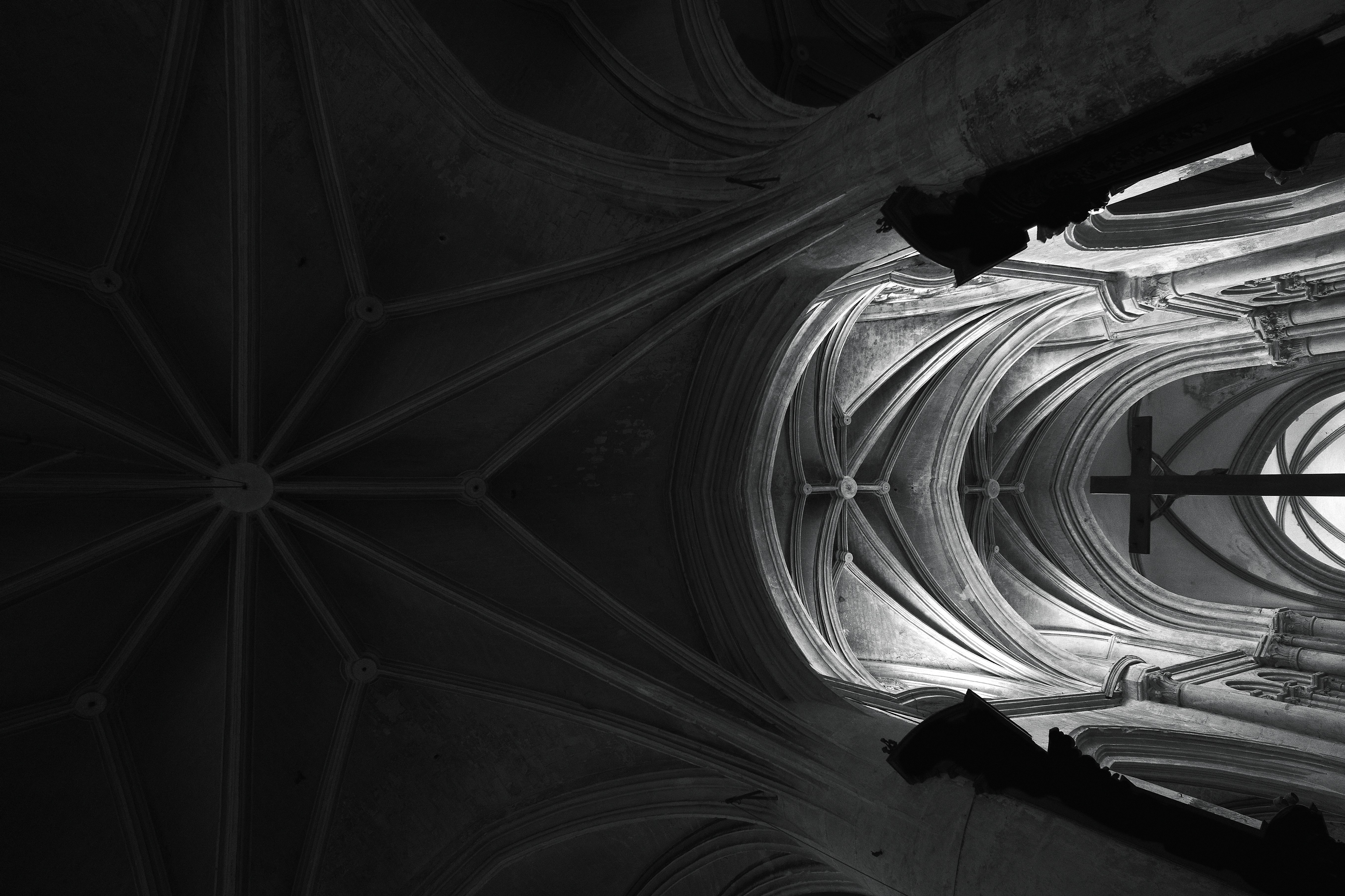 grayscale photography of crucifix placed inside cathedral, Somewhere in Lyon, France.