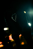 A silhouette of a couple laughing together under warm, ambient lighting.