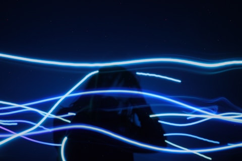 pre-lit blue string light through a person to show  headaches pass by