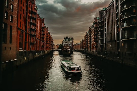 white boat on body of water in Speicherstadt Germany