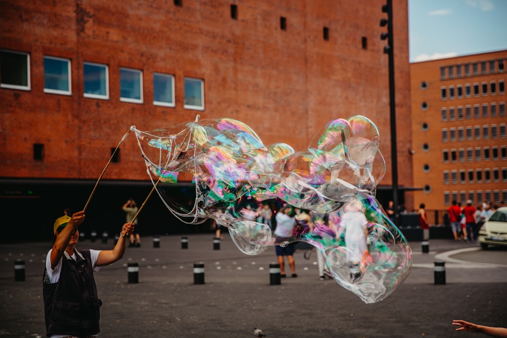 man doing bubble stunts at daytime