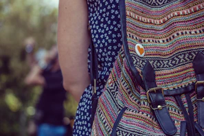 Outdoor shot of a person carrying a trendy backpack featuring bold prints and patterns