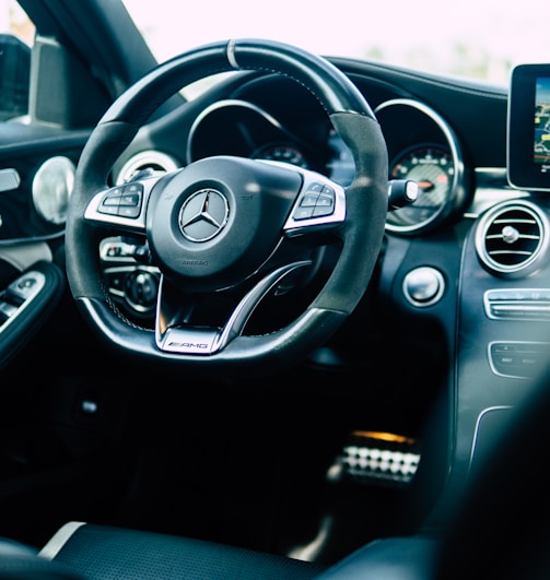 black Mercedes-Benz car steering wheel