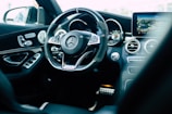 black Mercedes-Benz car steering wheel