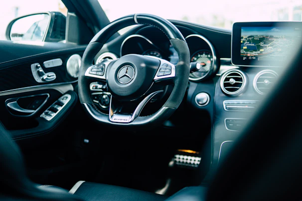 Mercedes dashboard featuring a modern touchscreen display and elegant wood trim.