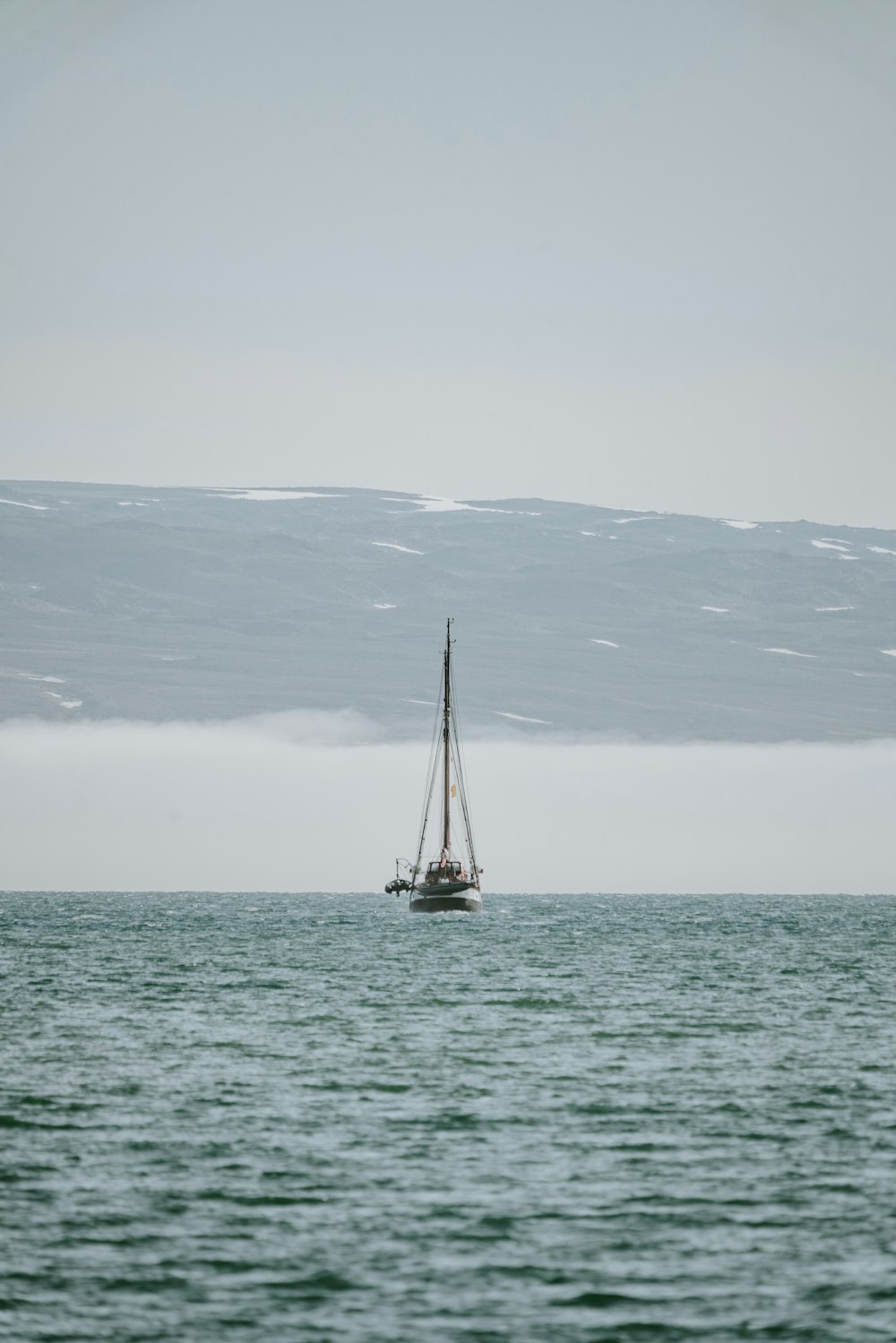 gray boat floating on body of water