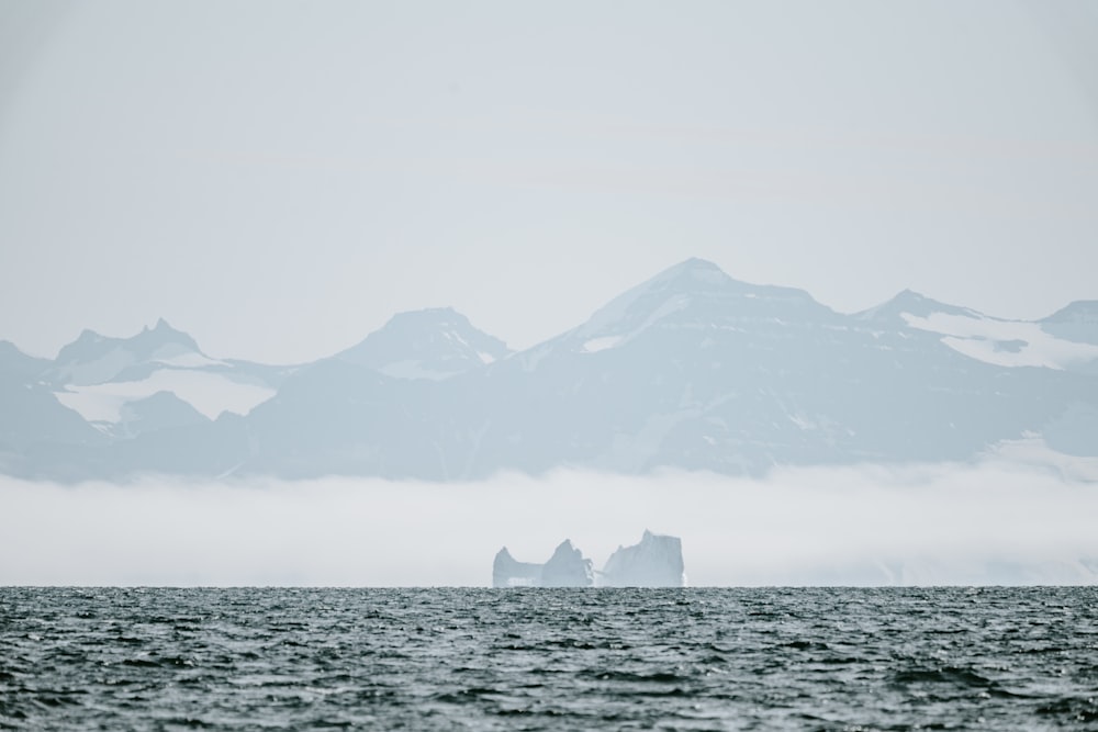 calm water with mountain range in the background