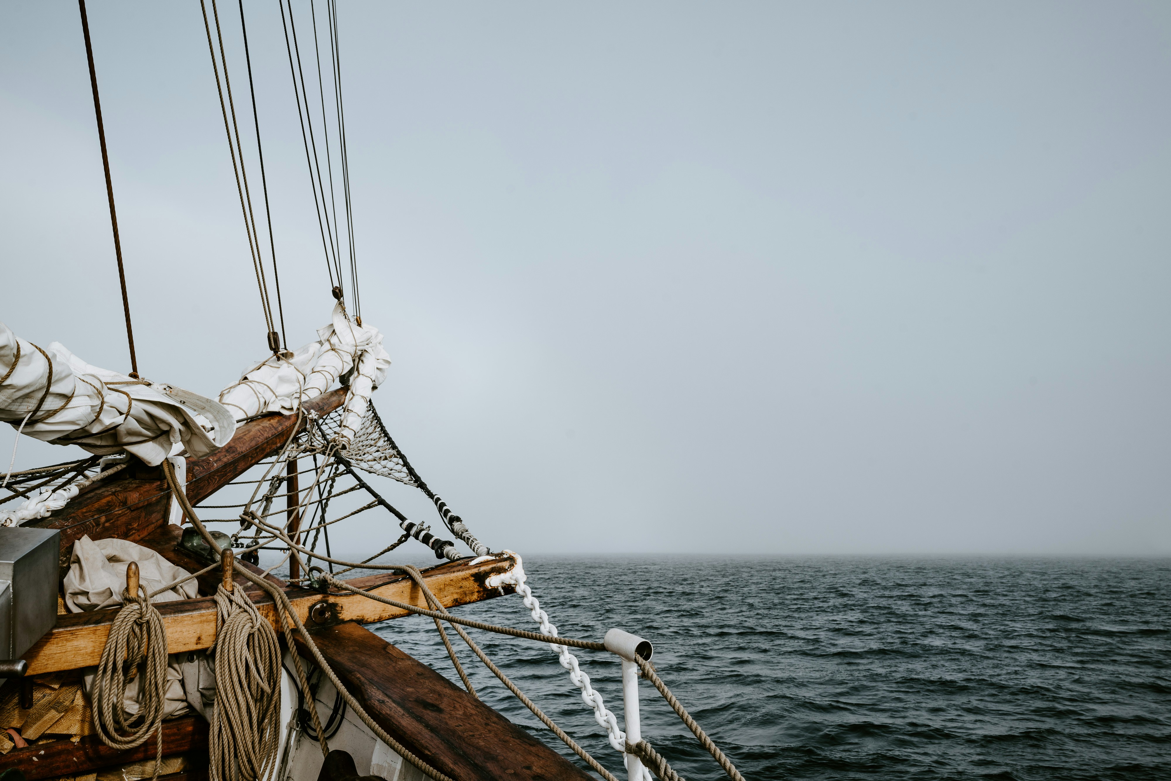 brown sailboat on body of water