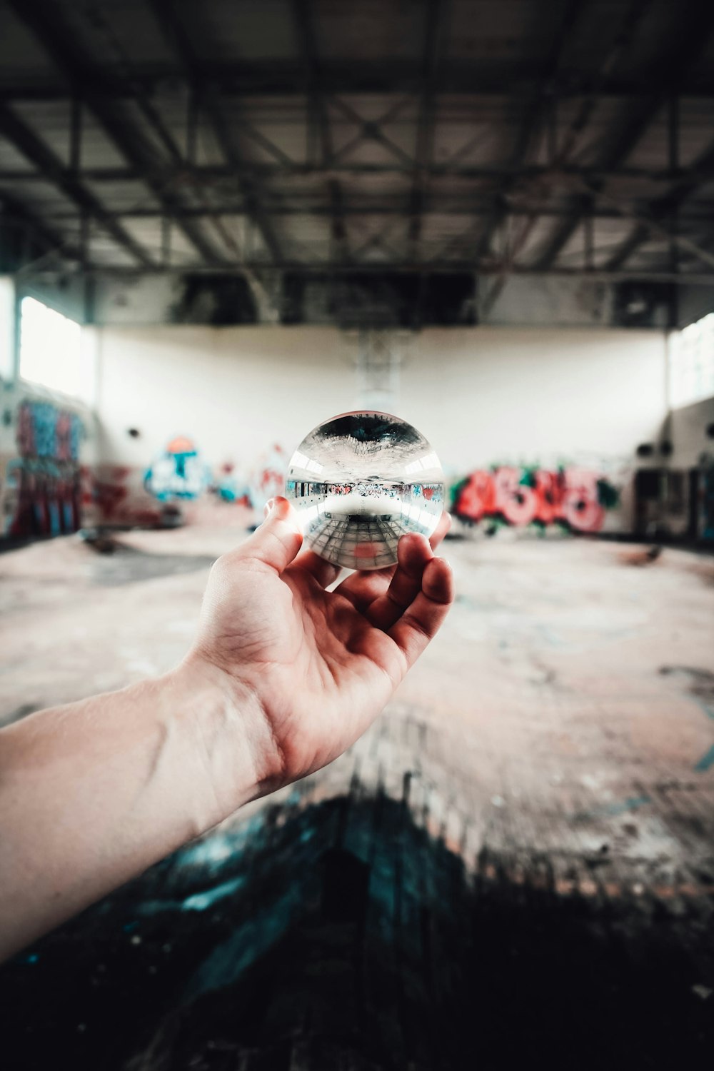 person holding clear glass ball