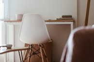 A minimalist desk paired with a comfortable chair in a modern workspace.