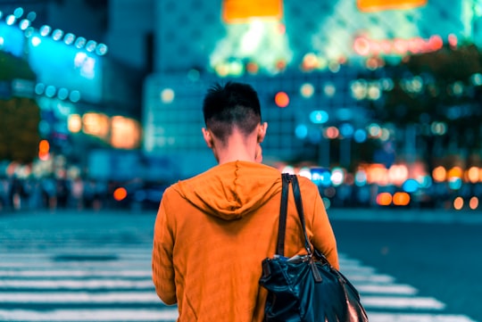 man walking on pedestrian lane in Shibuya Japan