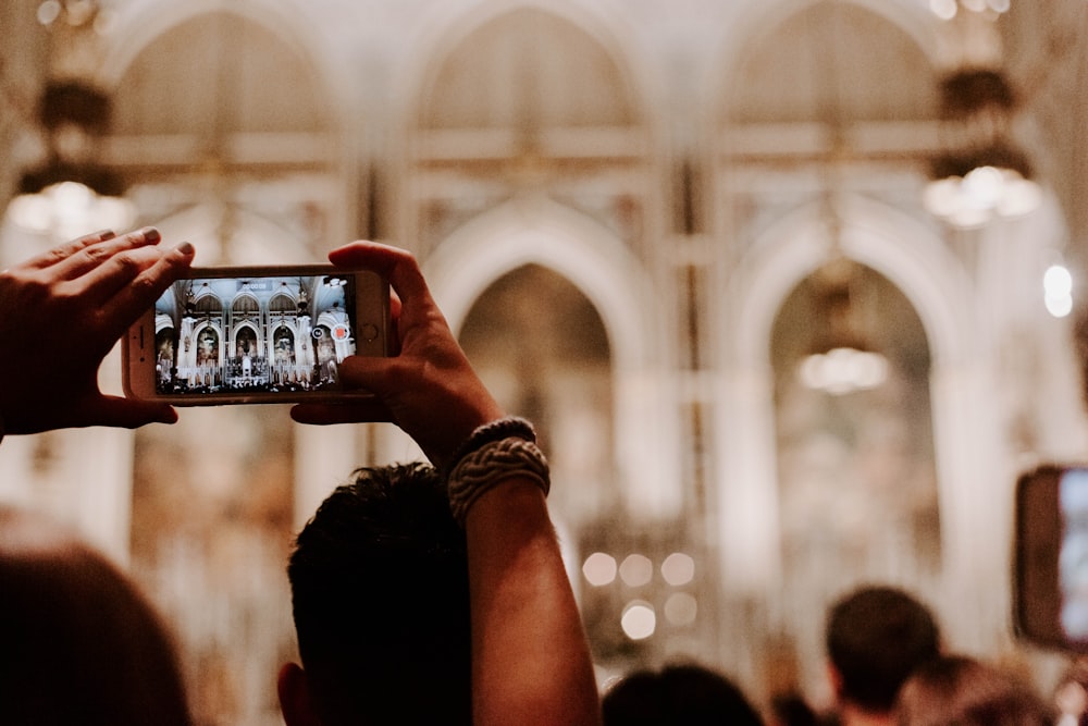 person taking a photo of cathedral