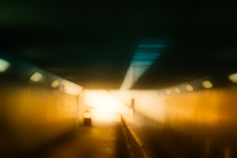 a blurry photo of a person walking down a tunnel